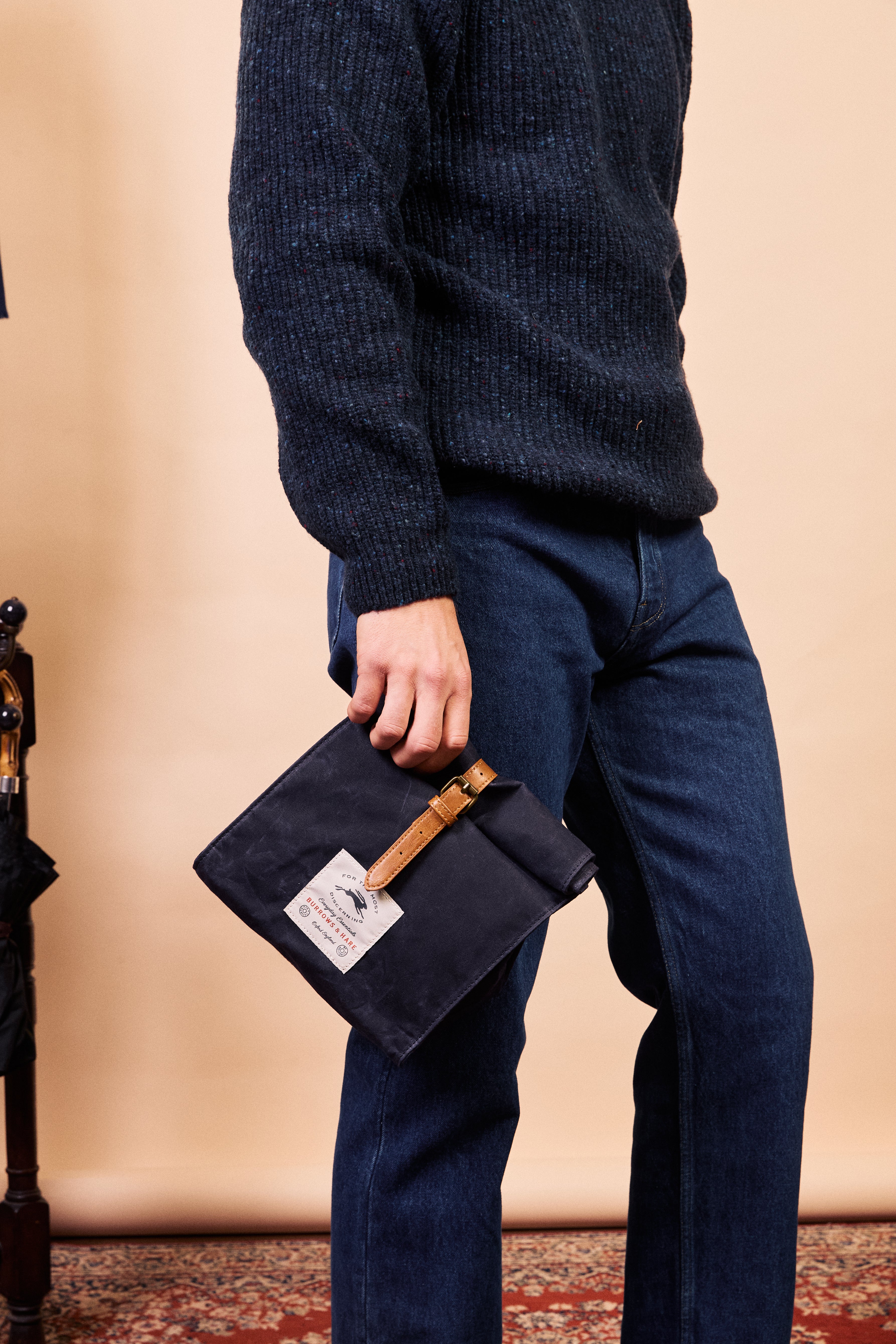 Side profile of the navy waxed canvas thermal lunch bag