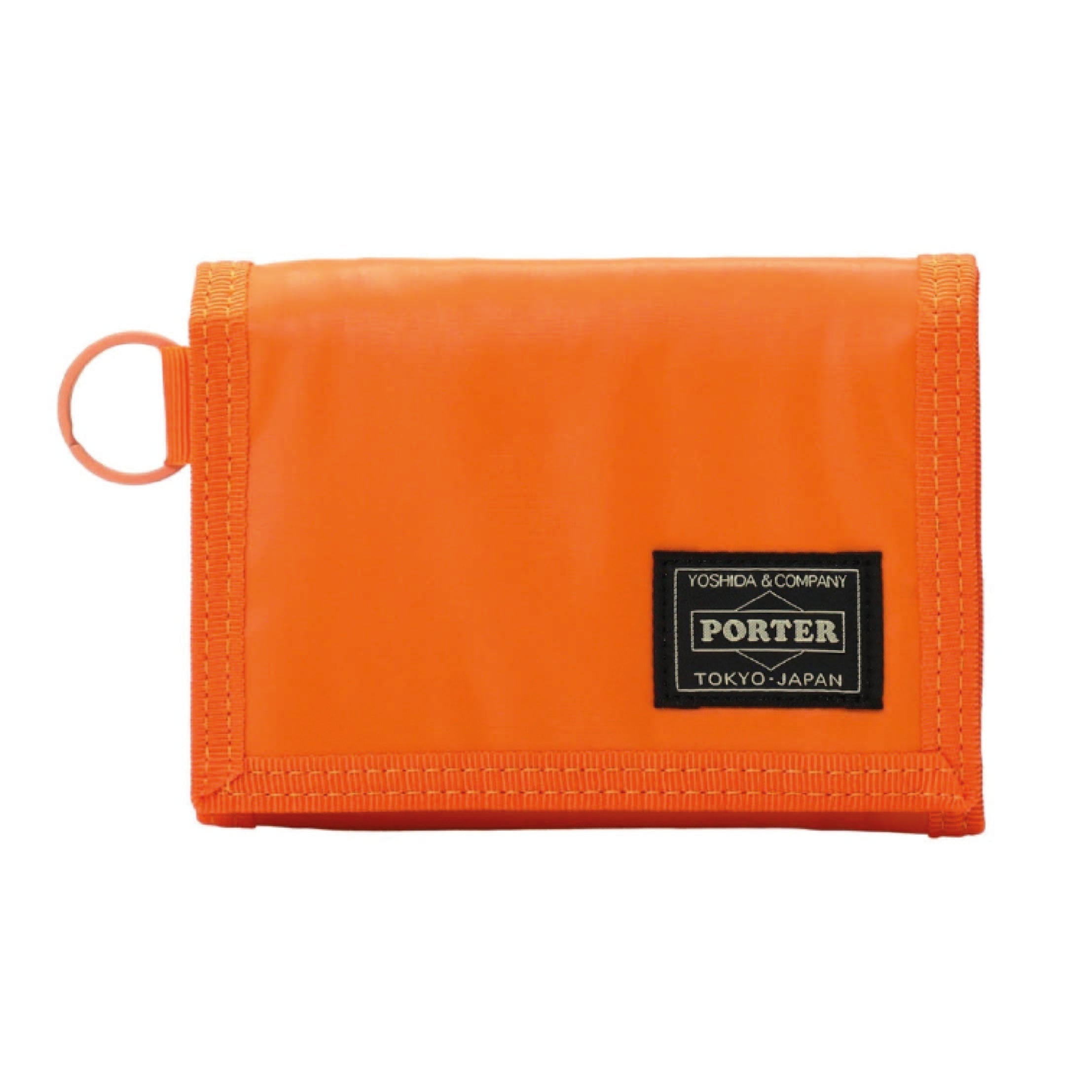 Porter Yoshida & Co. Capsule Wallet in orange — front view showing compact zip-around form and embossed Porter branding